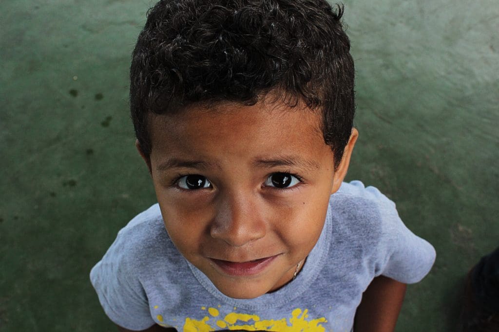 A photo of a little boy looking up into the camera.